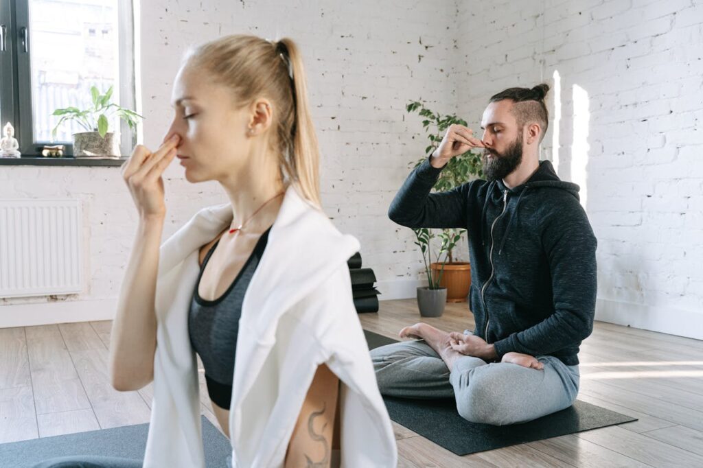 Person practicing mindful breathing, focusing on deep breaths to enhance mindfulness.